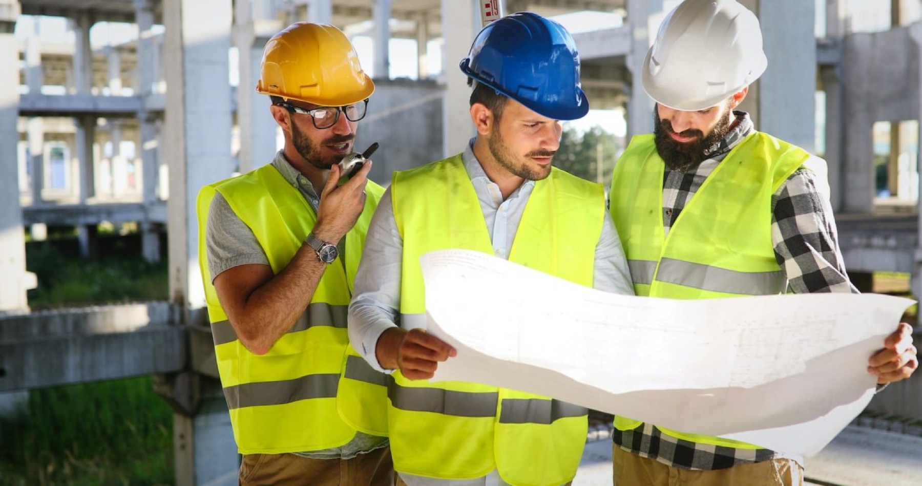 Engineering team reviewing construction drawings